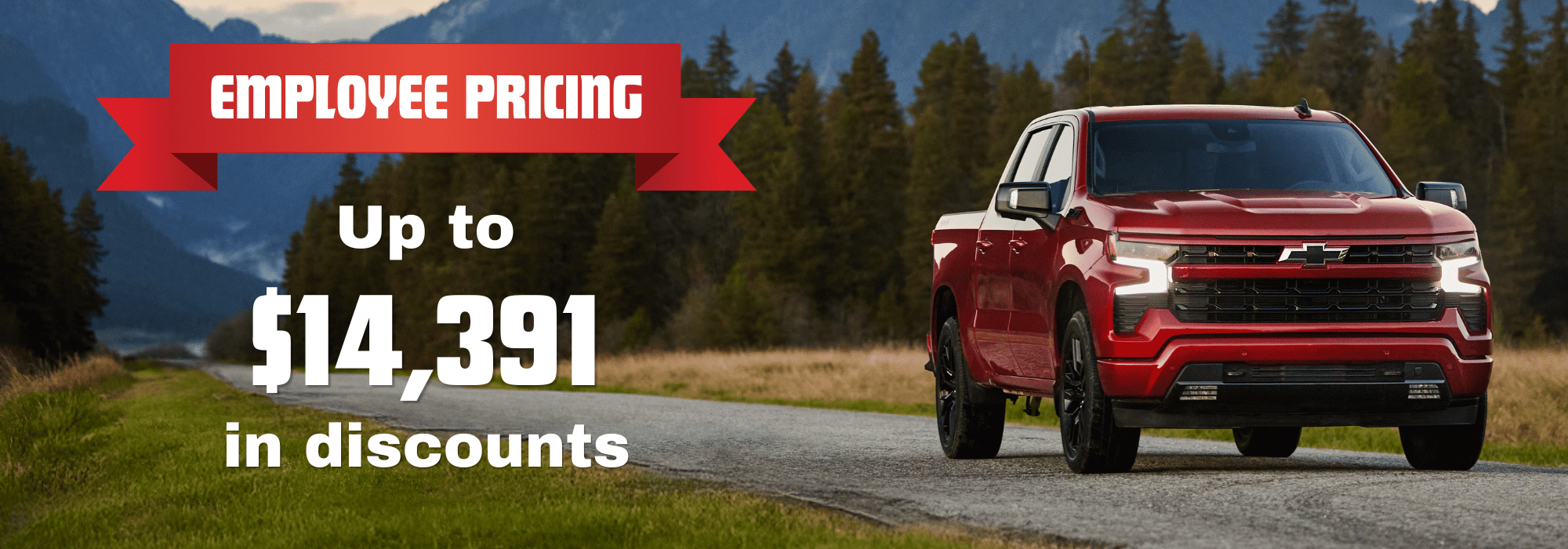 Red pickup truck driving on road with mountains. Text: "Employee Pricing, Up to $14,391 in discounts."