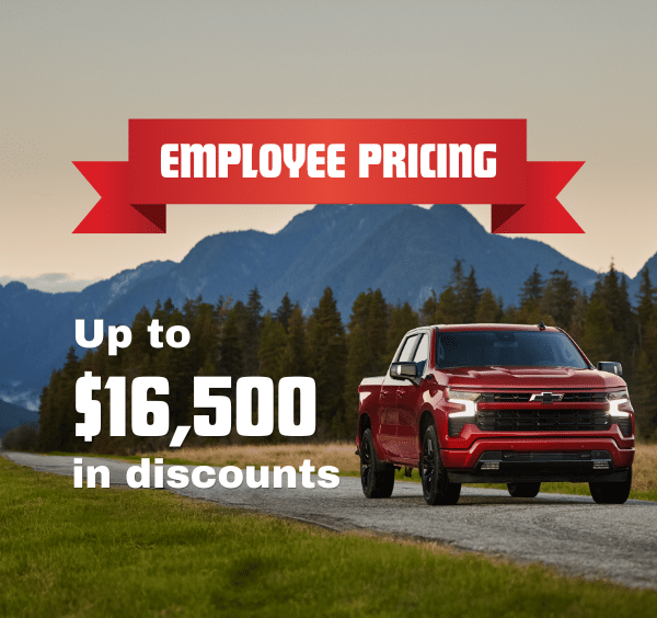 Red truck on a scenic road with mountains; text reads, "Employee Pricing. Up to $16,500 in discounts."