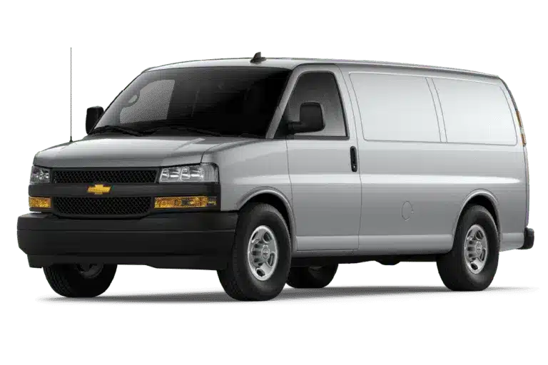 Silver Chevrolet Express van parked at an angle, showcasing its front and side view, highlighting its spacious design and commercial utility.