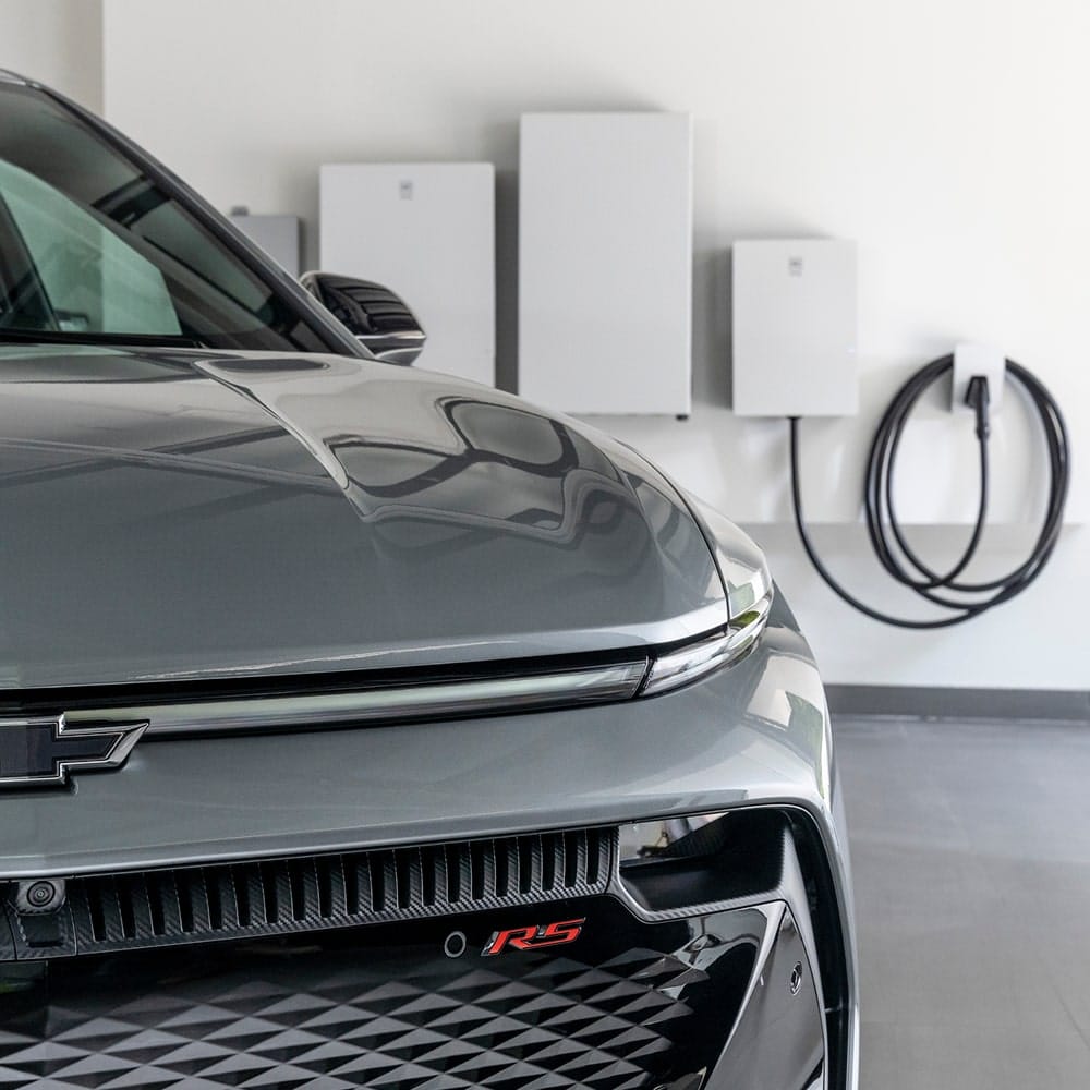 Sleek, modern SUV driving in an urban setting with a contemporary building backdrop.