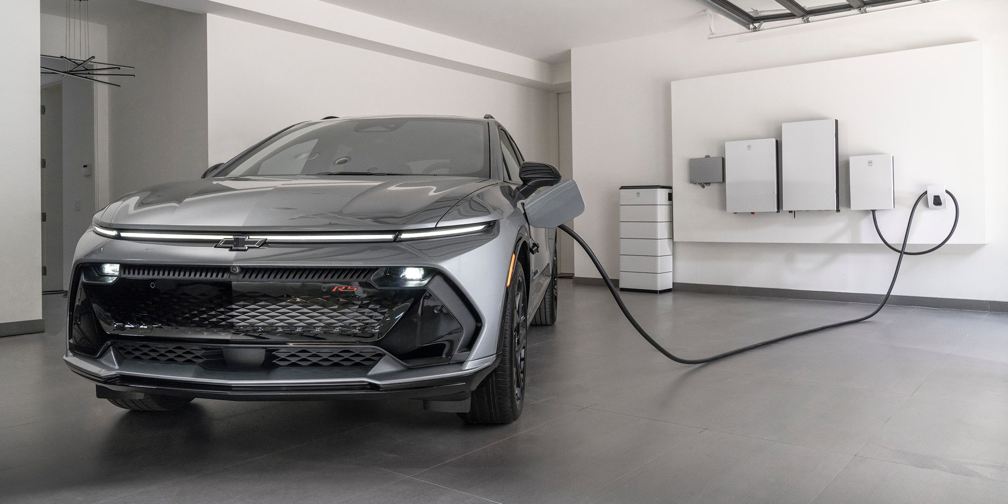 Charging an electric car with a white plug. Close-up of a red vehicle and a hand connecting the charger.