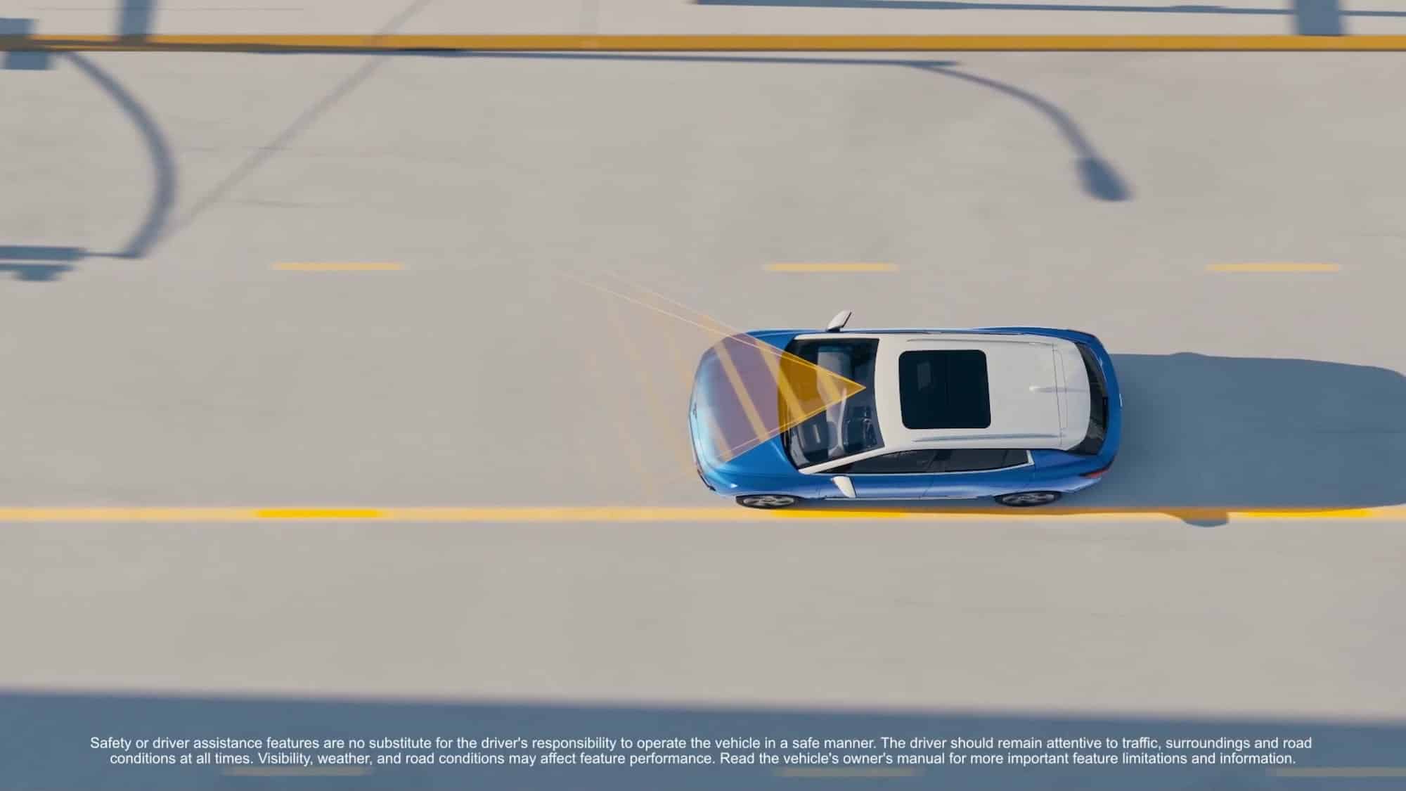 Red car with a highlighted sensor pattern driving on a road, showcasing advanced lane-keeping technology.